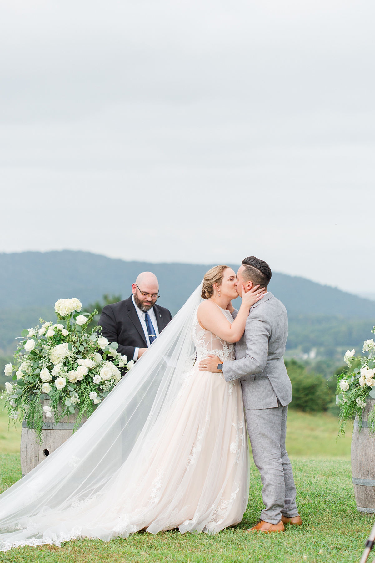 Ceremony Kiss with Mountain View at a Timeless Grace Estate Winery Wedding. Wedding Photography by Virginia Wedding Photographer Kailey Brianne Photography.