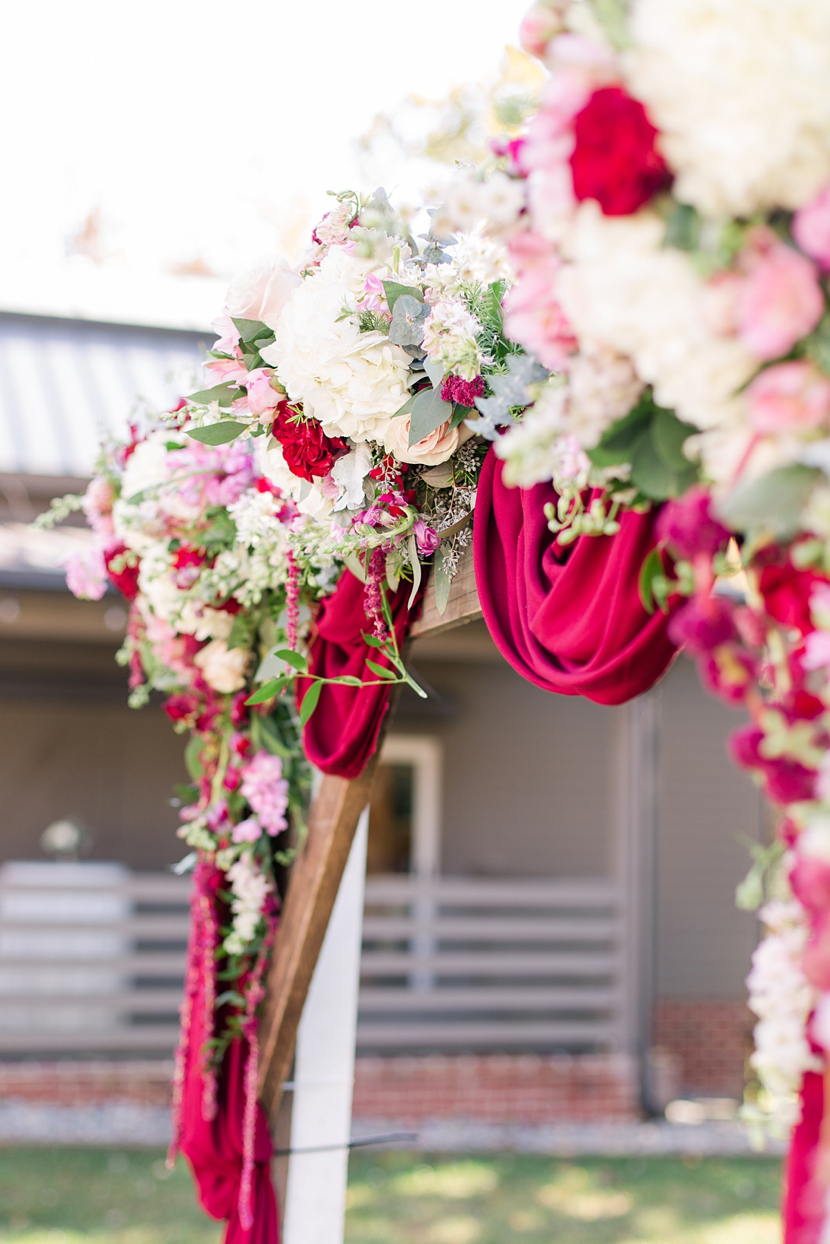 Ceremony Arch Florals at Hanover Tavern Fall Wedding. Wedding Photography by Richmond Wedding Photographer Kailey Brianne Photography. Florals by Lavender Lane Flowers & Gifts