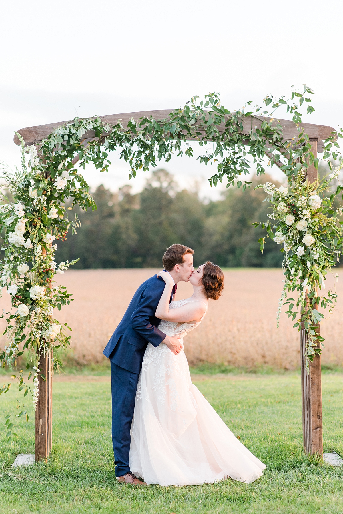 Sunset Bride and Groom Portraits Under Ceremony Arch at Burlington Fall Wedding. Wedding Photography by Richmond Wedding Photographer Kailey Brianne Photography. 