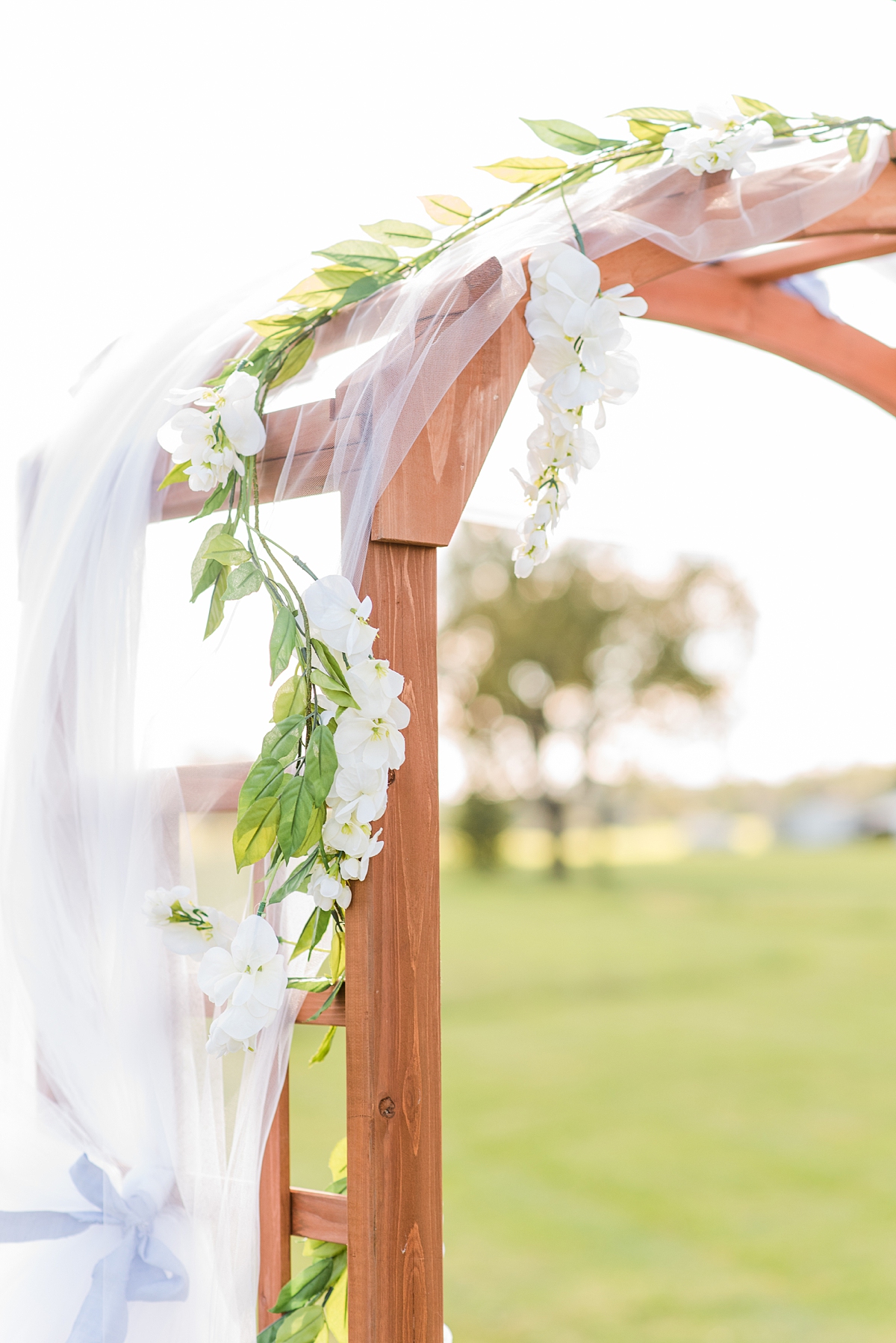 Ceremony Arch with Flowers at Rustic Wedding Ceremony at Granary at Valley Pike. Wedding Photography by Charlottesville Wedding Photographer Kailey Brianne Photography. 