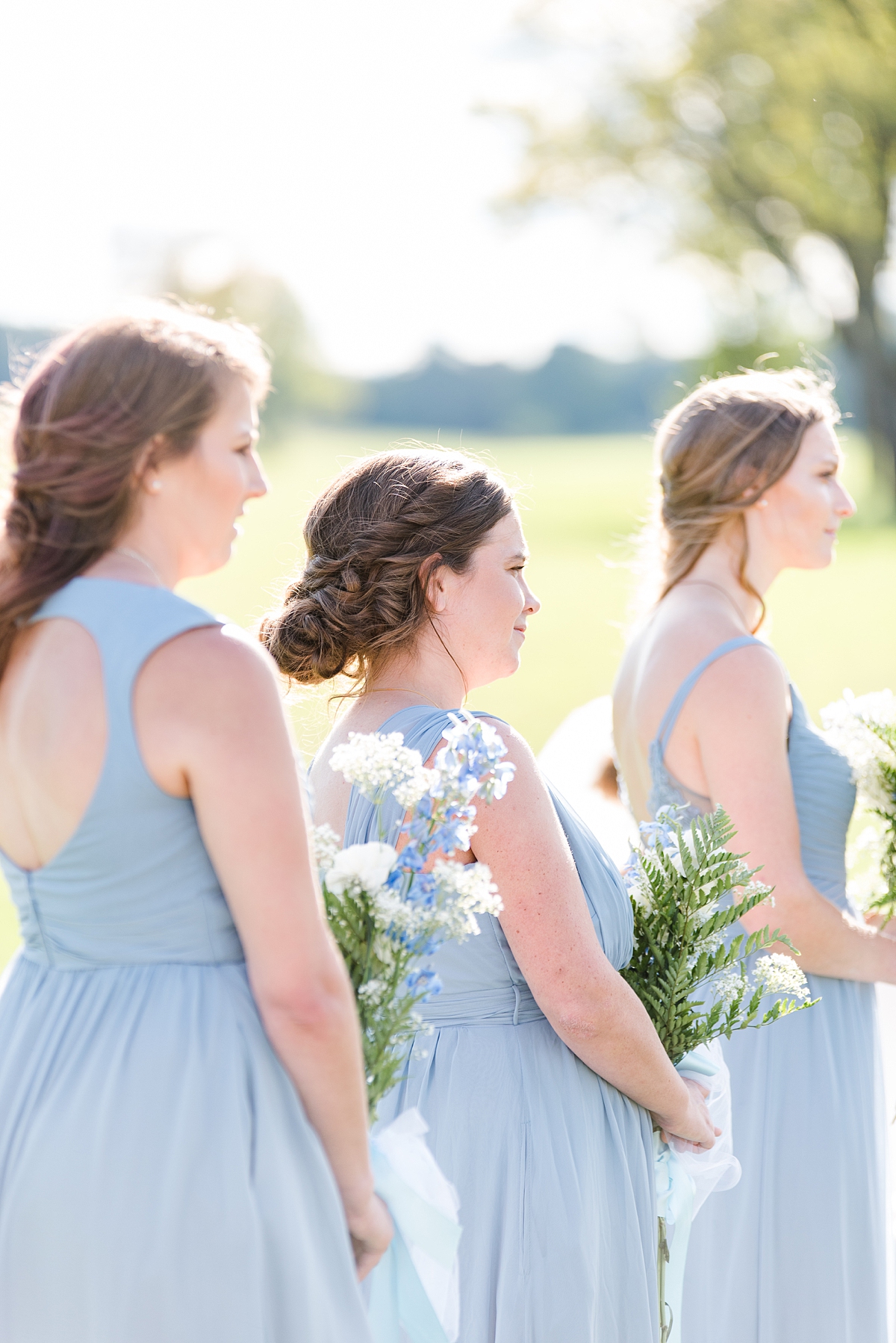Bridesmaids with Blue Dresses During Rustic Wedding Ceremony at Granary at Valley Pike. Wedding Photography by Charlottesville Wedding Photographer Kailey Brianne Photography. 