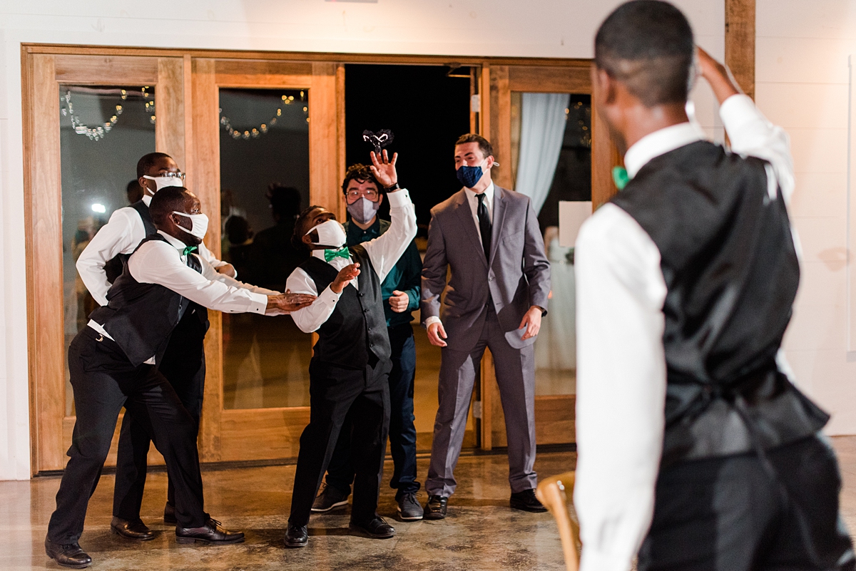 Garter Toss at Granary at Valley Pike Rustic Wedding Reception. Wedding Photography by Virginia Wedding Photographer Kailey Brianne Photography. 