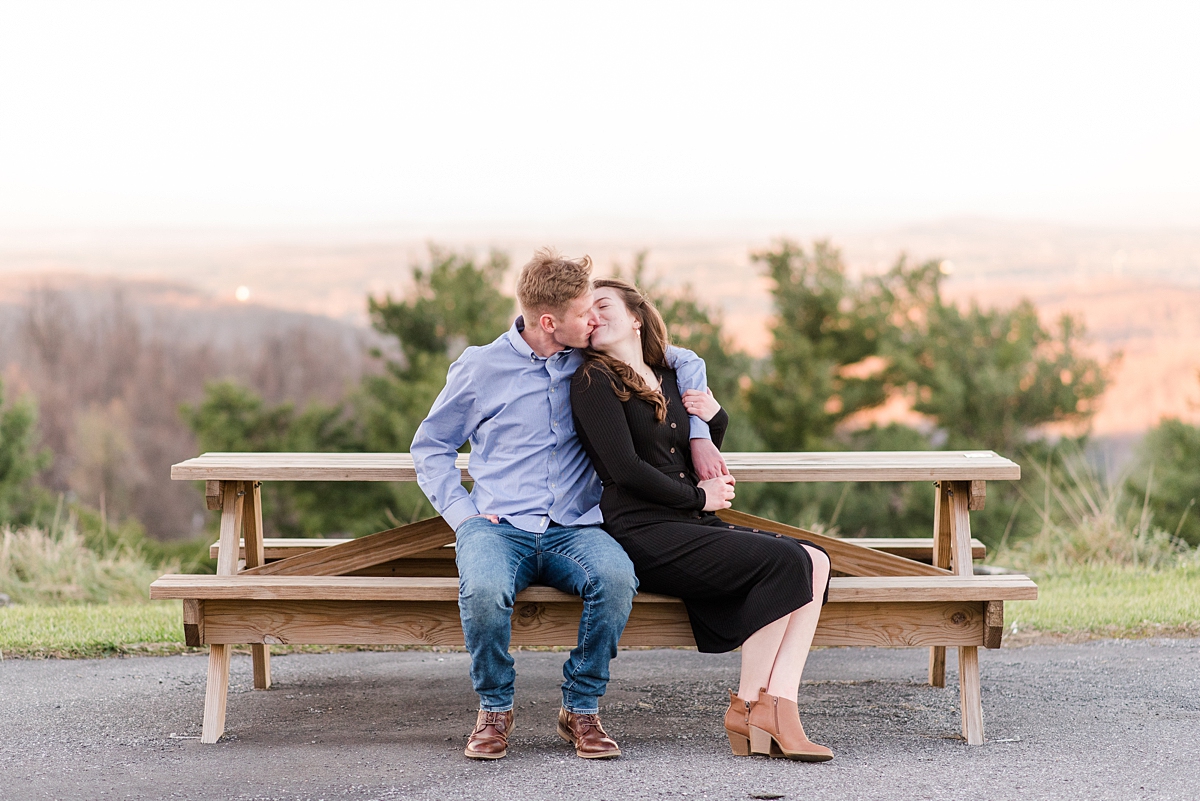 Scissor Kick Kiss with Mountain View at Fall Rockfish Gap Overlook Engagement Session. Photography by Richmond Wedding Photographer Kailey Brianne Photography.