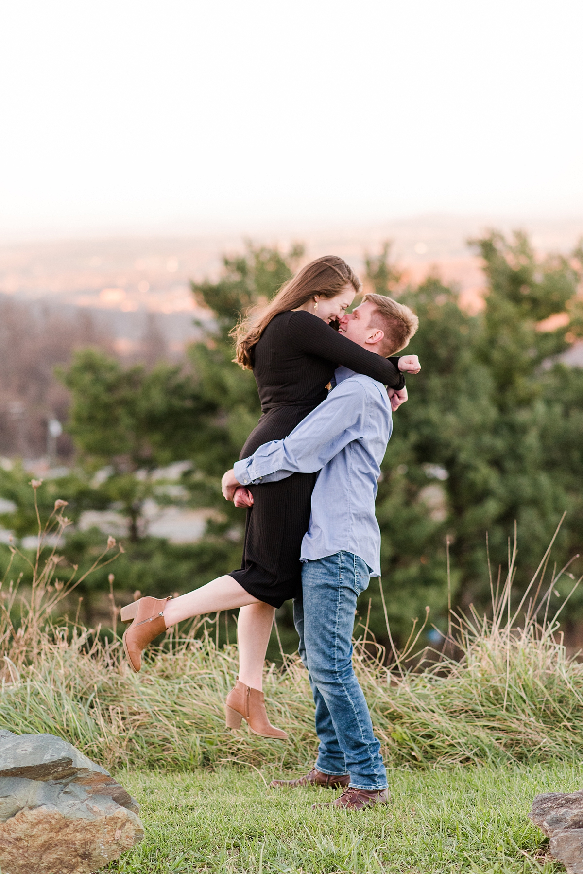 Scissor Kick Kiss with Mountain View at Fall Rockfish Gap Overlook Engagement Session. Photography by Richmond Wedding Photographer Kailey Brianne Photography.