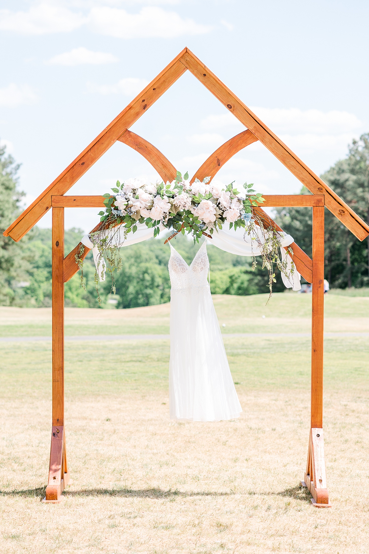 Bridal dress hanging on ceremony  spring Hanover wedding. Virginia Wedding Photographer Kailey Brianne Photography. 