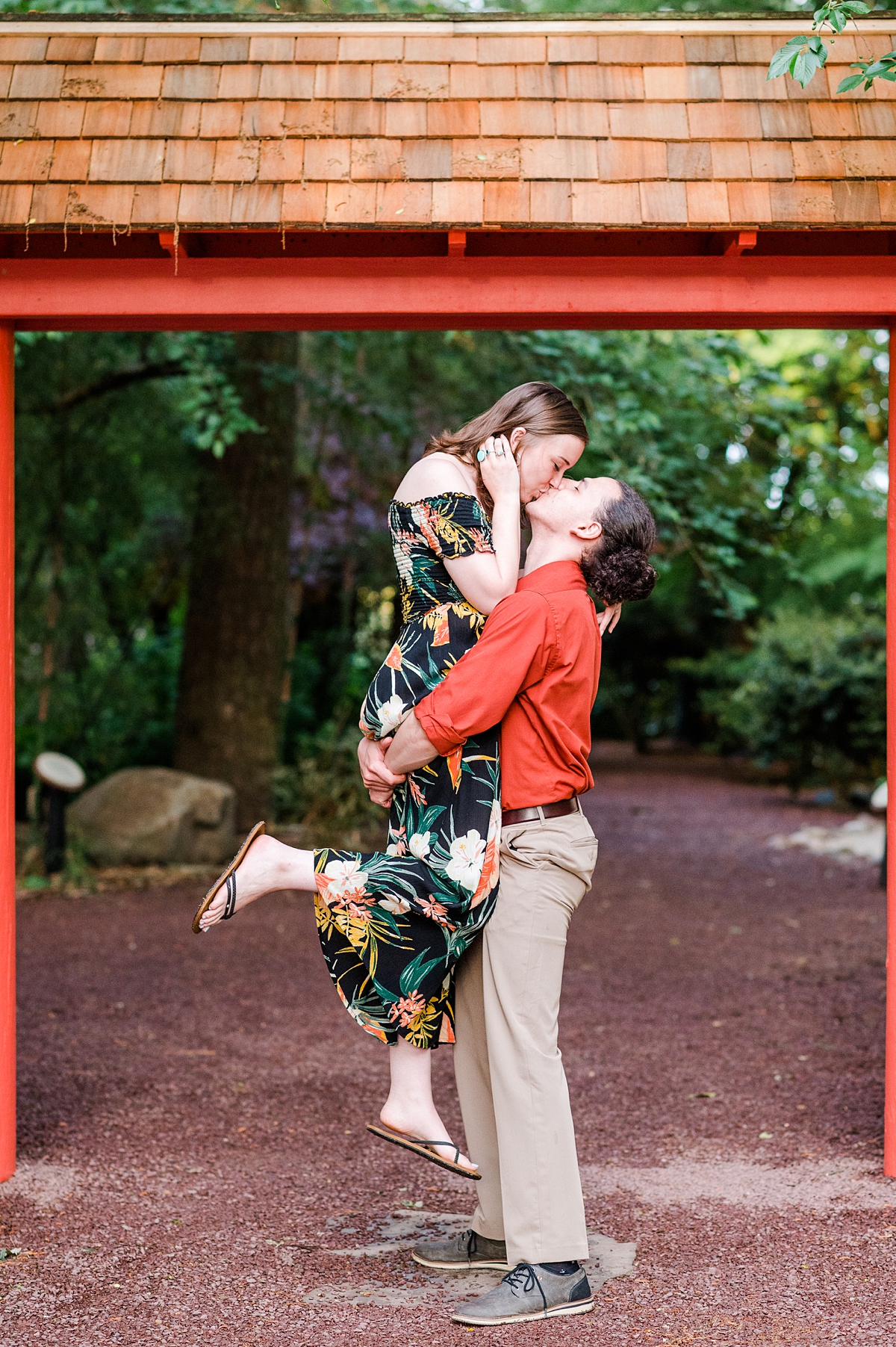 Scissor Kick Kiss during Spring Red Wing Park Engagement Session with blooms. Photography by Virginia Beach Wedding Photographer Kailey Brianne Photography. 