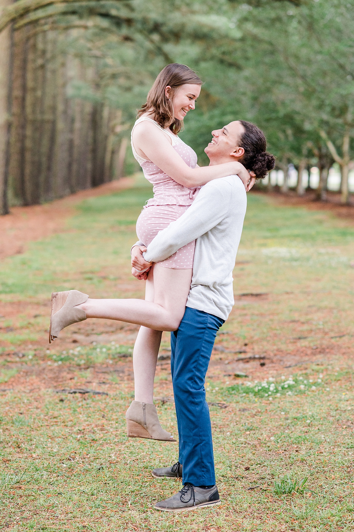 Scissor kick lift during spring Red Wing Park Engagement Session with arching trees. Photography by Virginia Beach Wedding Photographer Kailey Brianne Photography. 