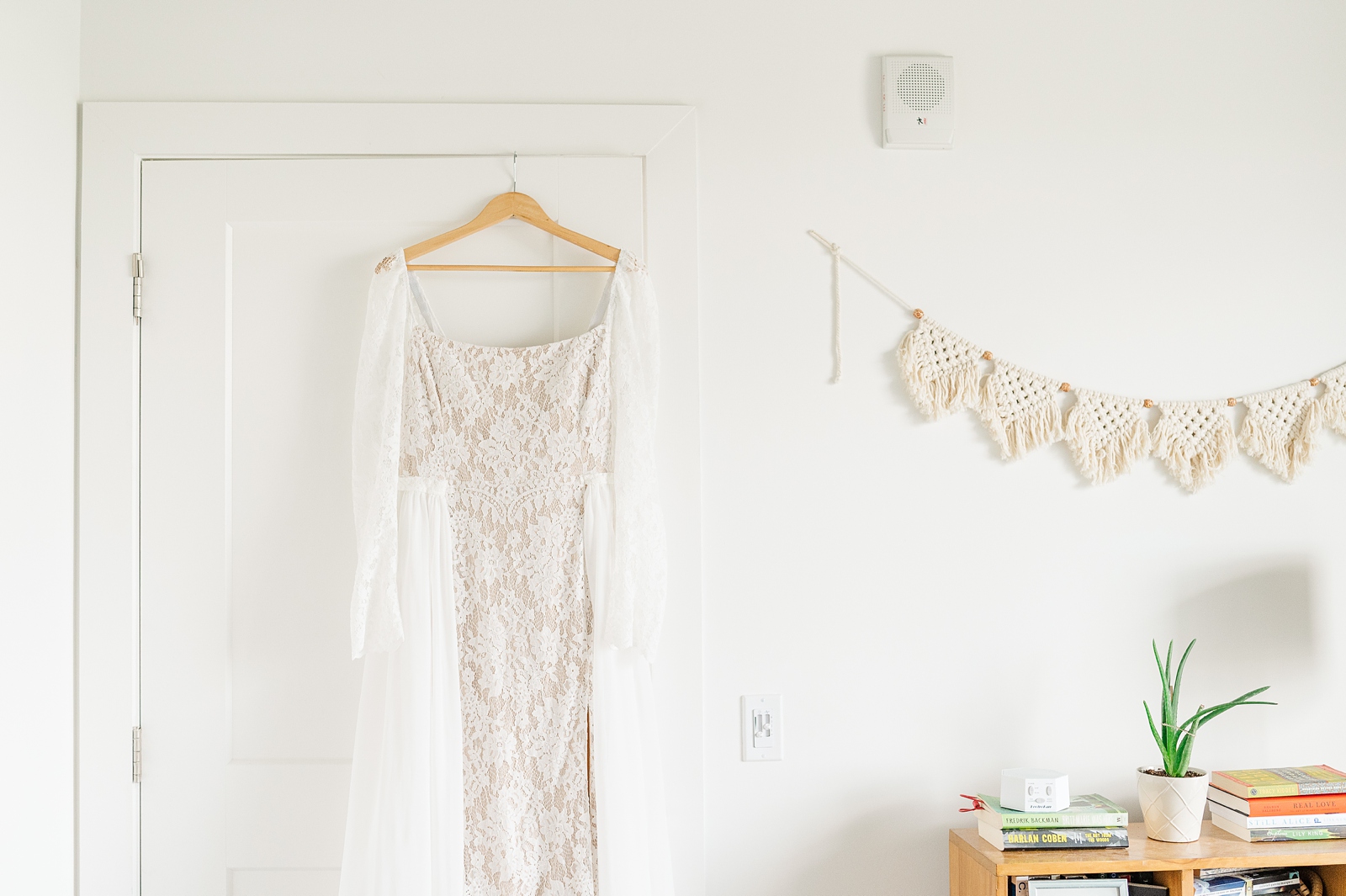 Wedding Dress Hanging in Apartment Before a Colorful Richmond Wedding. Photography by Richmond Wedding Photographer Kailey Brianne Photography.